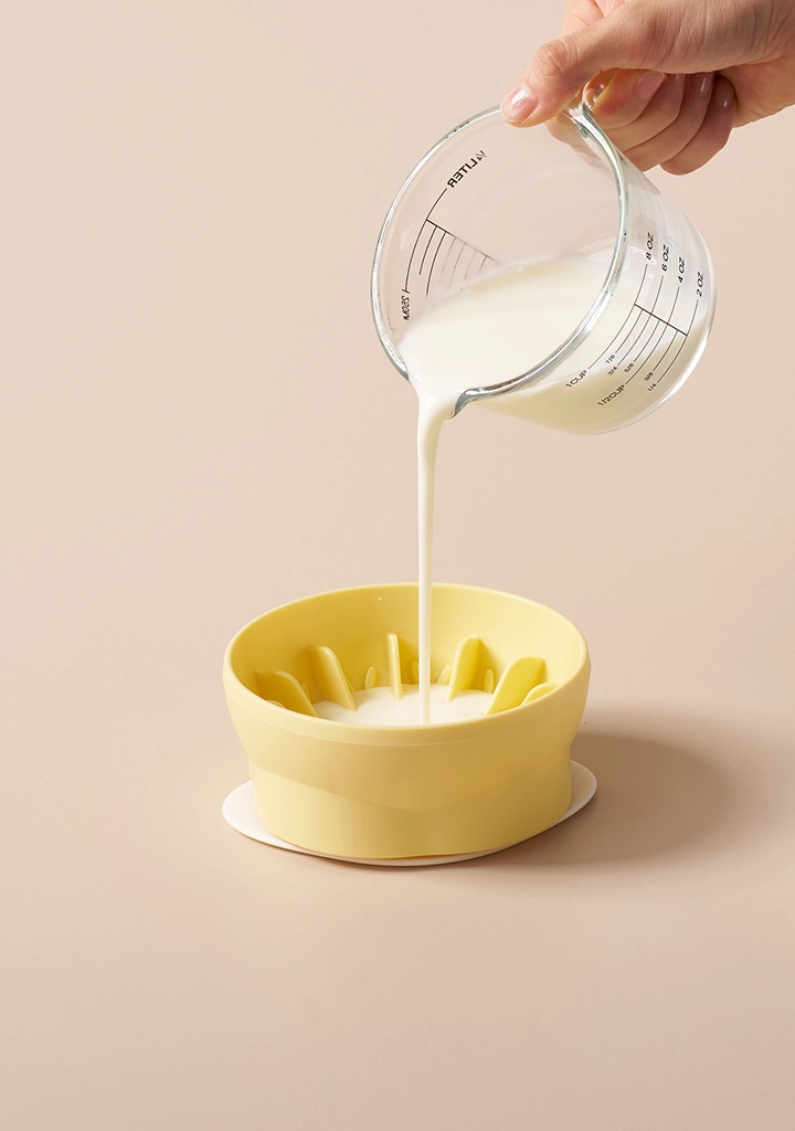 Pouring a liquid treat into the bowl
